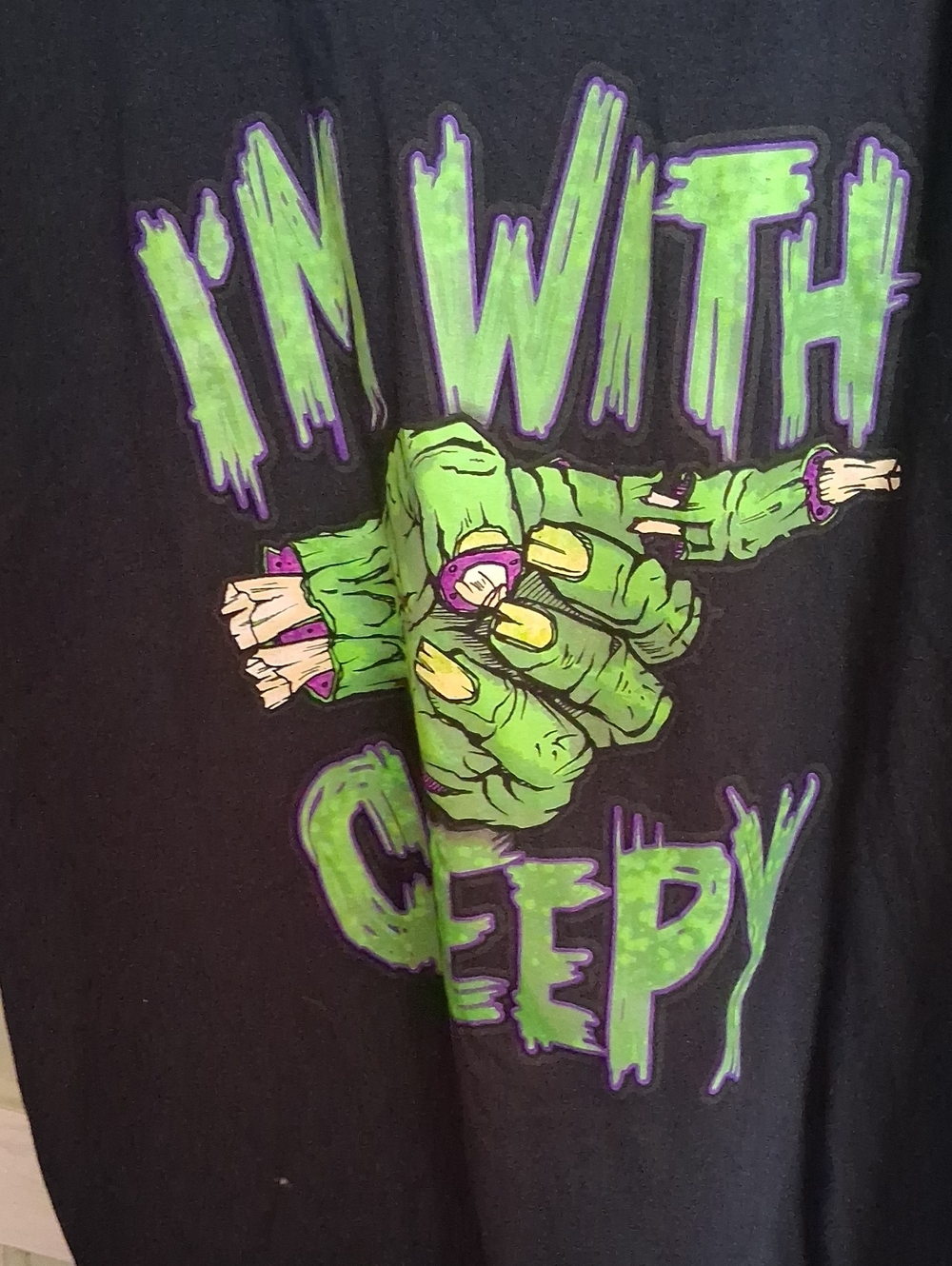 Unisex  Black Top with Green & Purple 'I'm With Creepy' Graphic .